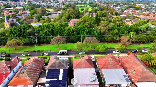 Drone panoramic aerial view of Sydney NSW Australia city Skyline and looking down on all suburban houses and streets of western Sydney of Burwood and Enfield