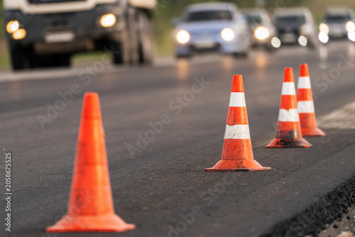 Obraz na plátně Road repair and new asphalt paving on highway with closed traffic lane, roadwork