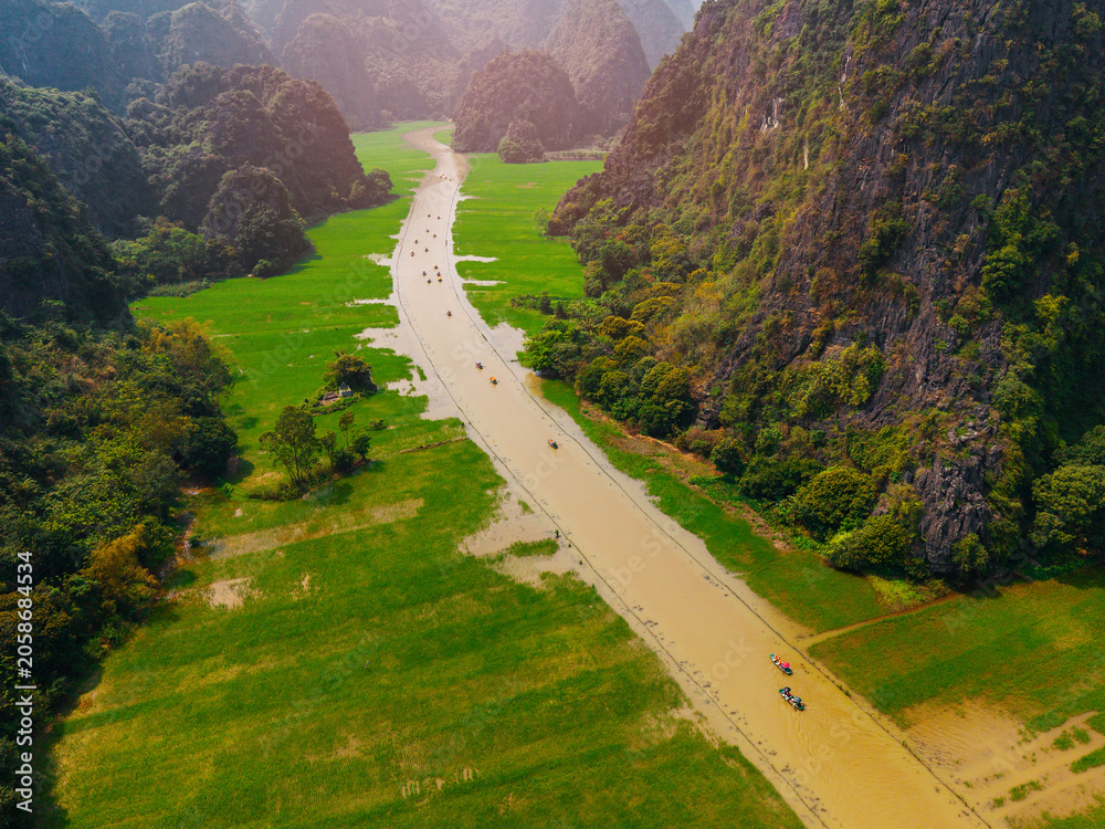 Obraz premium Scenic aerial view of tam coc river and lush landscapes in Ninh Binh, Vietnam