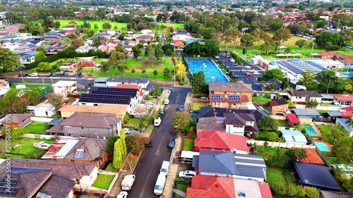 Drone panoramic aerial view of Sydney NSW Australia city Skyline and looking down on all suburban houses and streets of western Sydney of Burwood and Enfield
