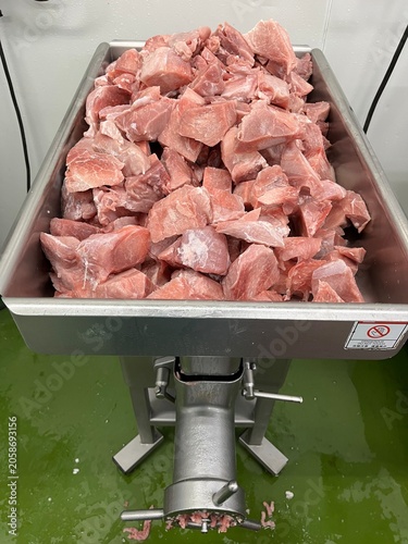 Fresh pork cubes prepared for grinding during food manufacturing operations. Raw material preparation stage supporting meat processing, ingredient production, and commercial food manufacturing.