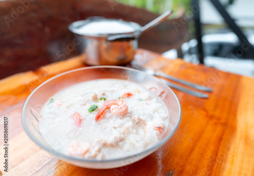 Close up view. Boiled rice soup in bowl with shrimp and minced pork is simple but healthy dish that is suitable for breakfast.