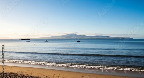 Calm Blue Seascape with Small Boats and Sandy Beach Shoreline