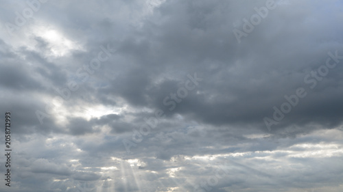 Dramatic Storm Clouds with Sun Rays Breaking Through Overcast Sky