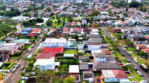 Drone panoramic aerial view of Sydney NSW Australia city Skyline and looking down on all suburban houses and streets of western Sydney of Burwood and Enfield