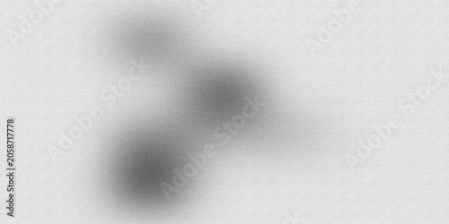Soft focus abstract swirling shape in black and white on textured background blurred
