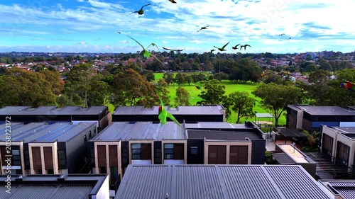 Drone panoramic aerial view of Sydney NSW Australia city Skyline and looking down on all suburban houses and streets of western Sydney of Burwood and Enfield