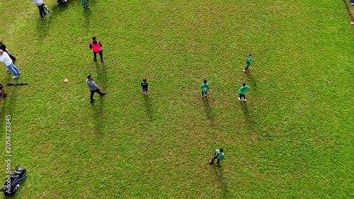 Children playing soccer with parents watching them in a western Sydney Park on a Sunday winter morning in Enfield Sydney NSW Australia