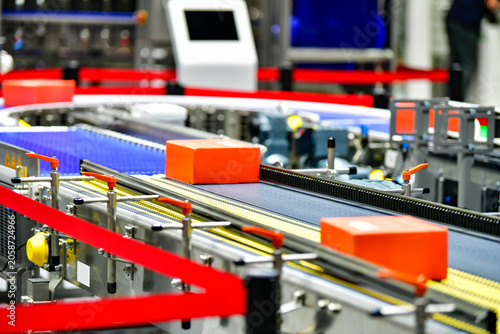 Modern industrial logistics warehouse with automated conveyor system handling smart packages