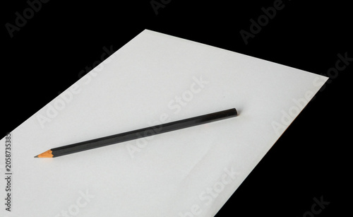 Pencil on a piece of white blank paper sheet. Image with copy space.