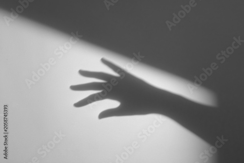 Fotografie hand shadow on wall background,hand with shadow,hands shadow overlay effects,sil