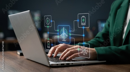 Professional typing on a laptop to manage an intelligent smart grid system with holographic wind turbine and battery storage icons, renewable energy tech, green modern technology business concept