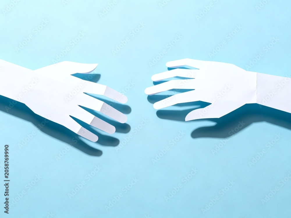 Fototapeta premium Paper Hands Reaching Against Blue Background