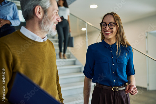 Business people collaborating while walking up stairs