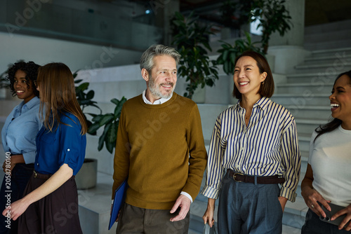 Diverse business team walking smiling in office building