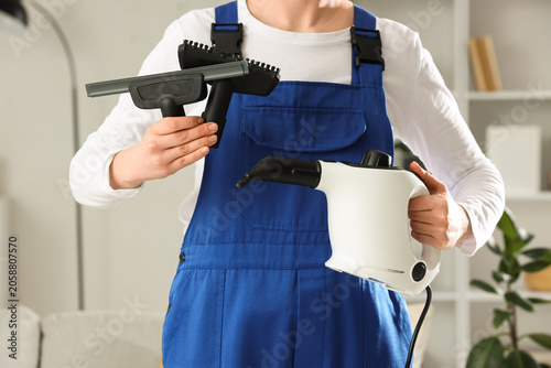 Female janitor with steam c...