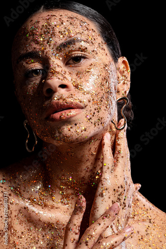 Woman with glitter on face ...