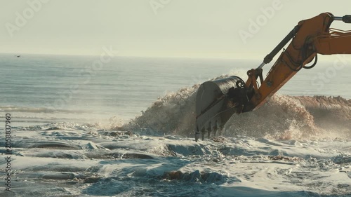 Excavator bucket working on beach nourishment project