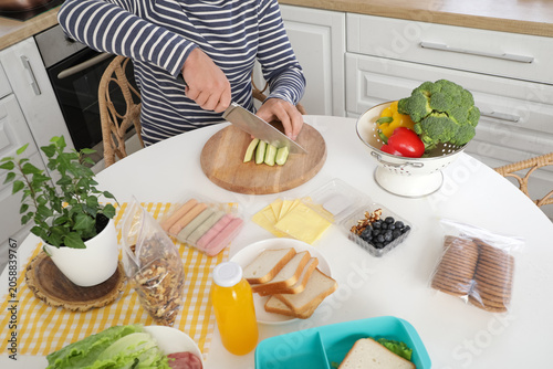 Young man cutting vegetable...