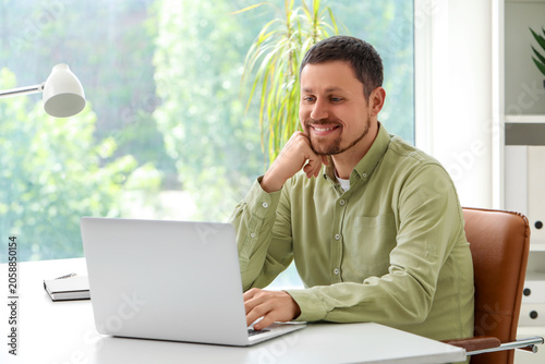 Man with laptop working in ...