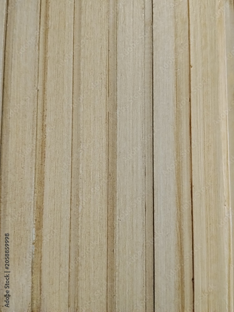 Fototapeta premium Light wooden plank texture with vertical grooves and natural grain pattern