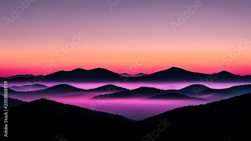 Silhouette mountains layered over a vibrant sunset sky.
