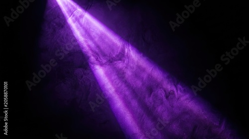Purple light beam glowing in dark abstract background