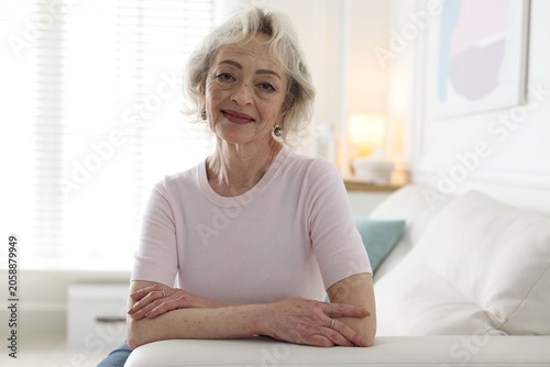 Bild auf Leinwand Portrait of senior woman on sofa at home