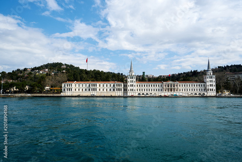 Imposing long white historical palace architecture running along the deep blue sea