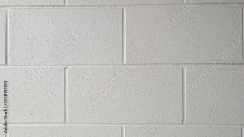 Photos Clean white cinder block wall texture with subtle shadows and grout lines, backg