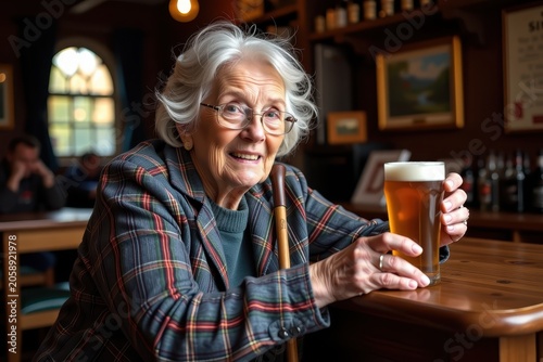 Warm, smiling elderly woman holds a pint of beer
