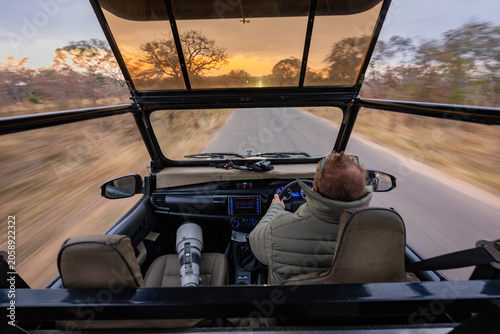 Fotografie Safari game drive at sunset with open vehicle