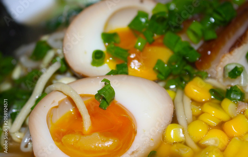 Ingredients for ramen preparation. Fresh egg and green onions for soup. Ingredients with selective focus. Details of egg green onion corn and other ingredients to make ramen.