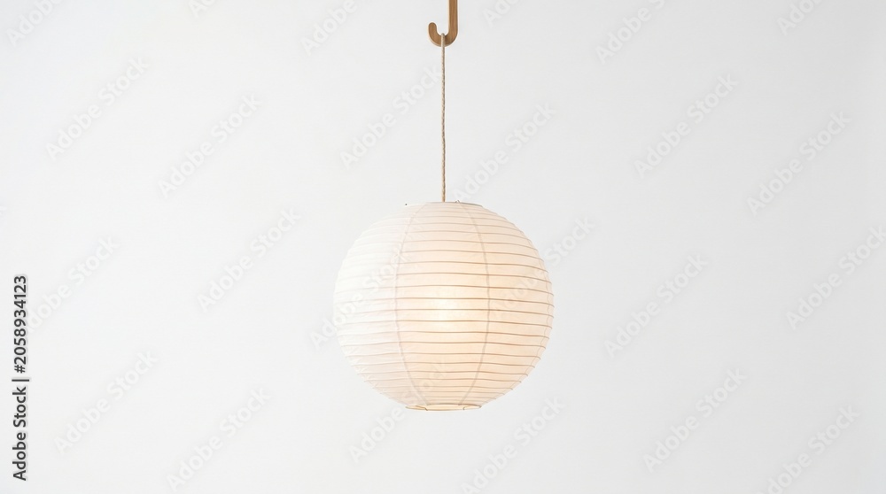 Obraz premium minimalist paper lantern hanging isolated on clean background representing soft ambient lighting, contemporary decor and serene interior design concept