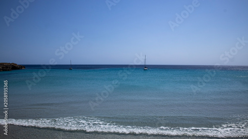 Two Sailboats on Calm Blue Ocean Water with Gentle Waves