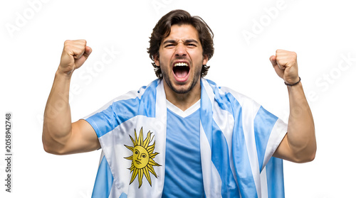Passionate Football Fan Celebrates Victory Wearing Flag and Jersey