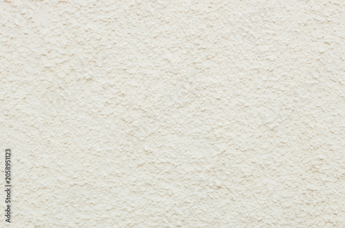 Beautiful view of textured street wall of pale yellow building.
