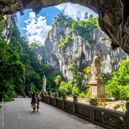 Cave entrance to lush valley view