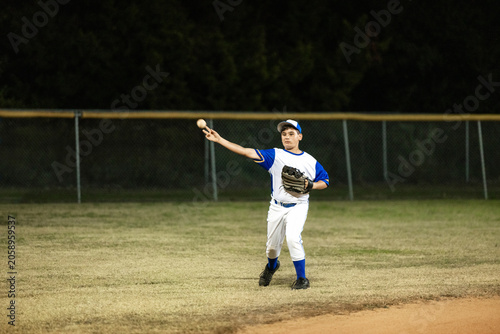 Young outfielderFielder Prepares to Throw Ball at Night Game