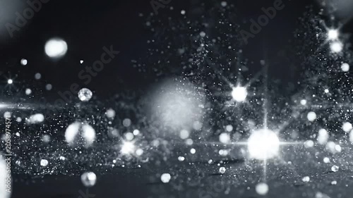 Shiny silver spheres and glitter particles bouncing and sparkling on a dark surface, macro slow motion shot with bokeh and lens flares