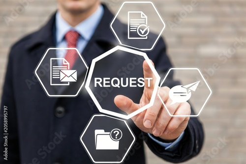 Businessman pressing a virtual button with the word request on a digital interface screen