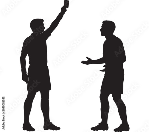 Referee holding up a red card while confronting a soccer player who is arguing during a professional match.