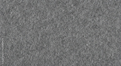 Close-up view of gray felt fabric texture with soft fibrous surface and woven textile pattern