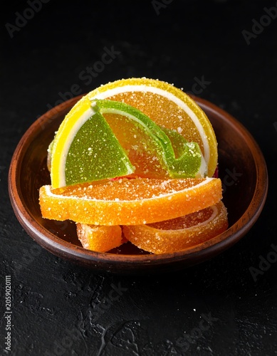 A small brown bowl contains sugared orange and lemon slices