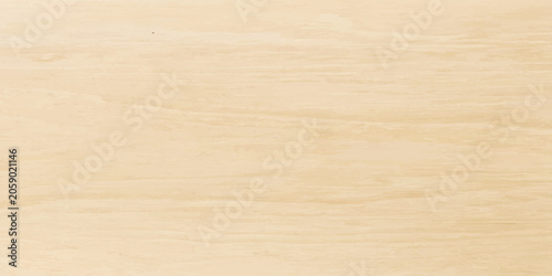 A close-up shot reveals the natural grain of a light-colored wooden surface, showcasing subtle variations in texture and tone that evoke warmth and simplicity.
