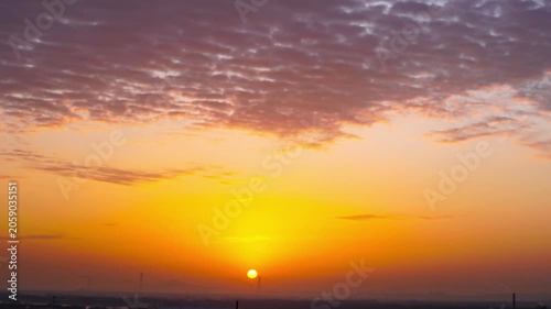 Sunset Sky Over Distant Landscape with Dramatic Clouds