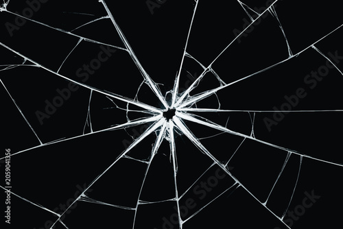 Realistic shattered glass texture with a radial bullet hole crack on black background vector illustration