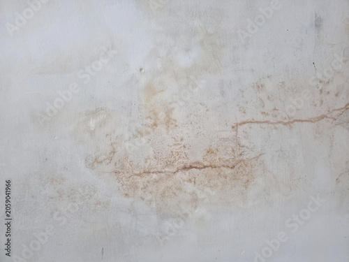 Water damaged wall with brown stains and a crack