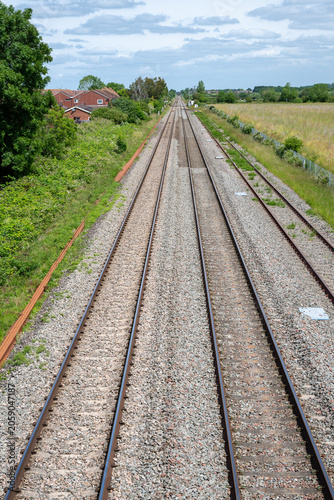 Double-track railway main line running straight through countryside near Ashchurch, Tewkesbury, Gloucestershire