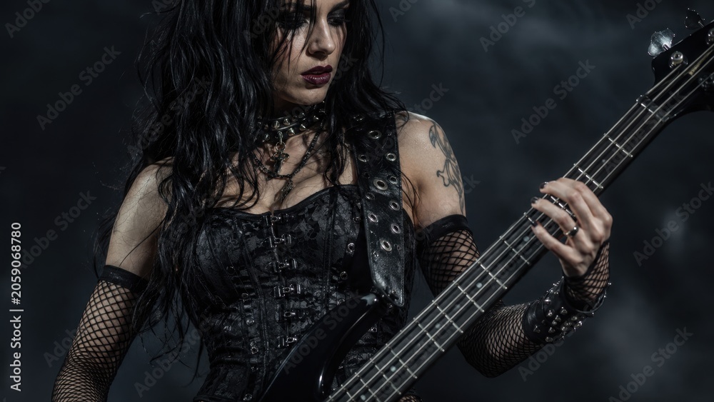 Obraz premium Gothic Female Bass Guitarist Performing Dark Alternative Music